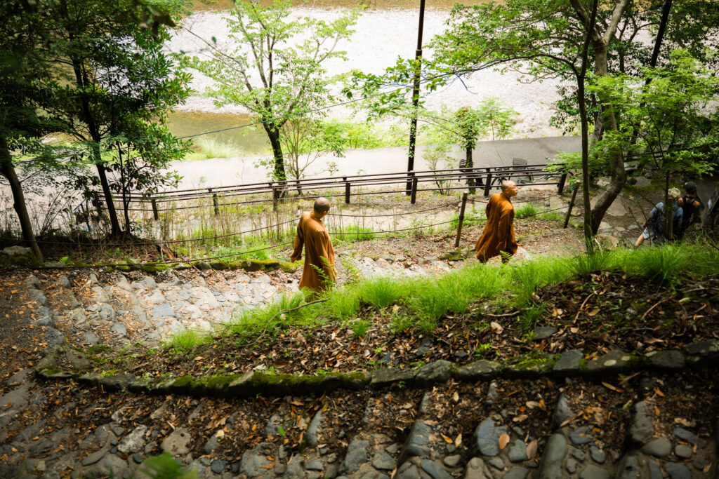 Monks walk down stairs in Kyoto, Japan